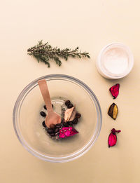 Bowl with homemade scrub ingredients, coffee, petals, cream, sponge. eco cosmetic concept.