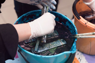 Close-up of hands working in container