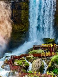 Scenic view of waterfall against sky