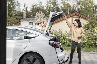 Woman closing car boot