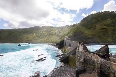 Scenic view of sea and mountains against sky