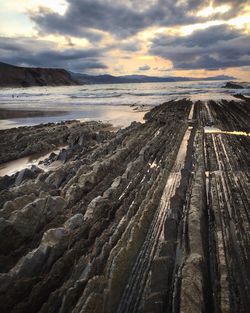 High angle view of rocky shore against cloudy sky at acantilado flysch