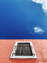 Low angle view of building against blue sky