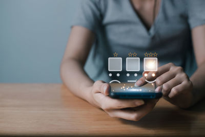 Midsection of woman using mobile phone