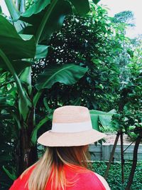 Rear view of woman wearing hat against trees