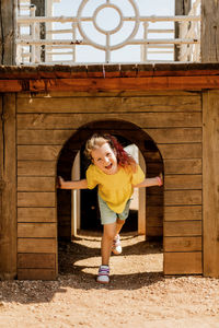 A charming little girl is having fun and playing on the playground. happy childhood, summer time