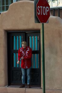 Full length of man standing against door