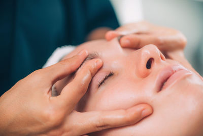 Close-up of woman getting massage therapy at spa