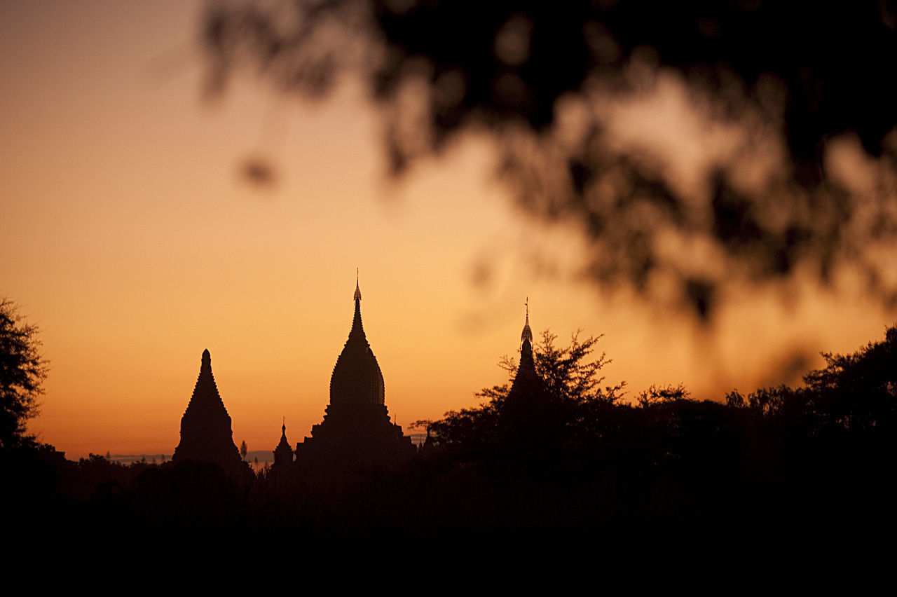 SILHOUETTE OF PAGODA AGAINST SUNSET SKY