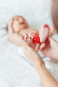 Cropped hands of mother holding baby feet