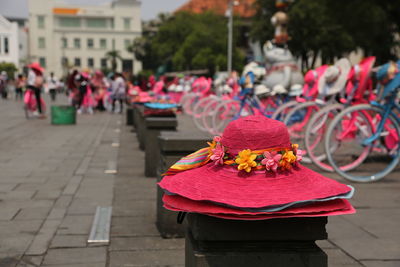 Close-up of hats on bollard by street in city