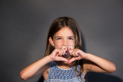 Portrait of a smiling girl over black background