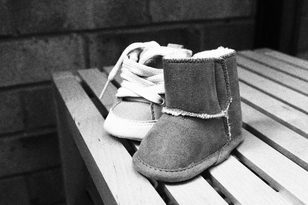 HIGH ANGLE VIEW OF SHOES ON WOODEN TABLE