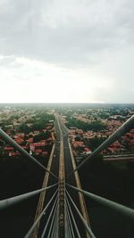 View of cityscape against cloudy sky