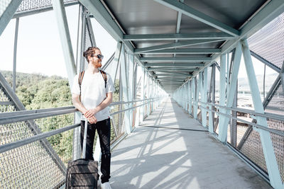 Full length of young man walking on bridge