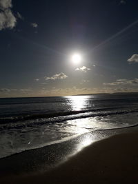 Scenic view of beach against sky during sunset