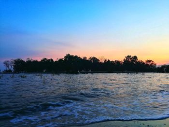 Scenic view of lake against sky during sunset