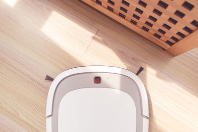 High angle view of wooden table against white wall