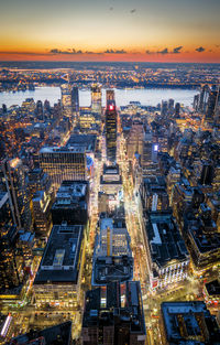 Aerial view of city lit up at sunset