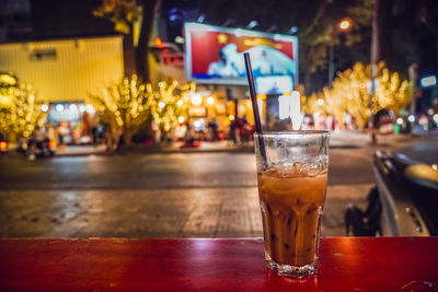 Close-up of beer glass on table at night