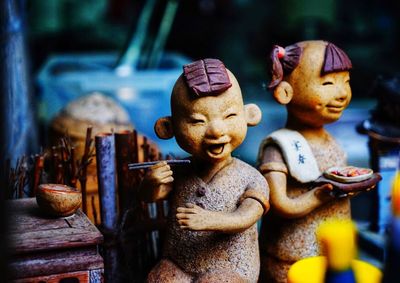 Close-up of buddha statue on table