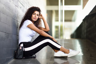 Portrait of woman sitting in corridor