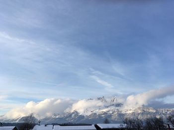 Aerial view of snow covered landscape against sky