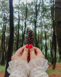 Midsection of woman in forest