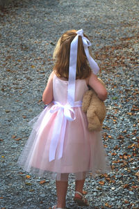 Rear view of girl walking outdoors