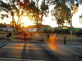 People on road at sunset