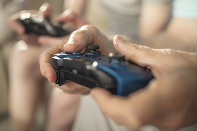 Close-up of hand holding video game controller