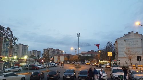 Traffic on city street and buildings against sky