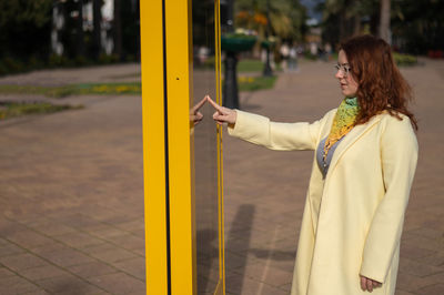 Rear view of young woman standing in park