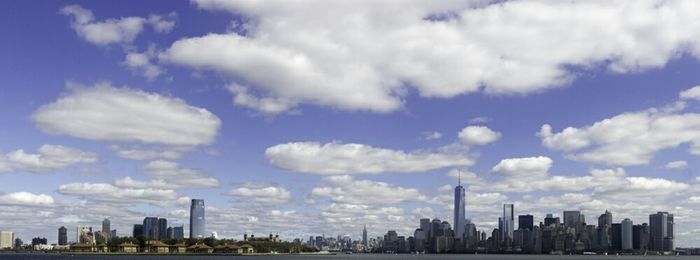 City skyline against cloudy sky