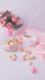 Hand holding pink flowers at home