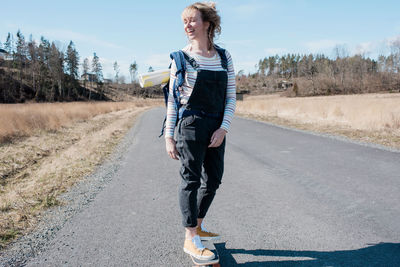 Woman enjoying skating along a country road from yoga class