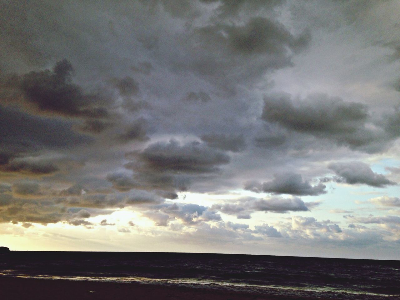 sea, horizon over water, sky, scenics, tranquil scene, beauty in nature, water, tranquility, cloud - sky, cloudy, beach, nature, idyllic, cloud, weather, overcast, shore, outdoors, dusk, storm cloud