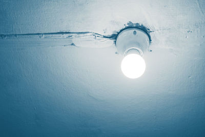 Low angle view of illuminated light bulb