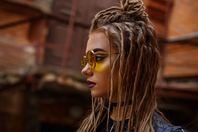 Close-up portrait of young woman wearing sunglasses