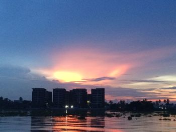 View of illuminated city against sky during sunset