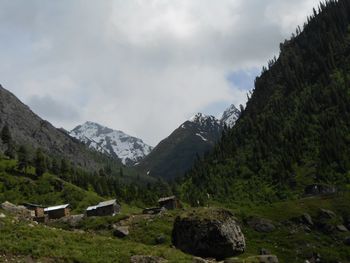 Scenic view of mountains against cloudy sky