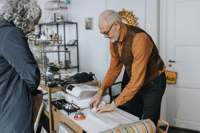 Side view of man working in workshop