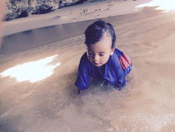 Baby boy in water at seashore