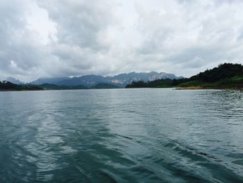 Scenic view of lake against cloudy sky