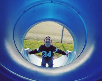 Cute boy playing in play equipment