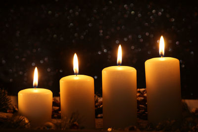 Close-up of lit candles on table during christmas