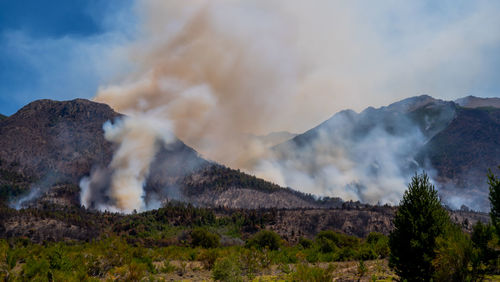 Smoke emitting from volcanic mountain against sky