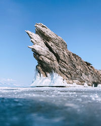 View of frozen sea against clear blue sky