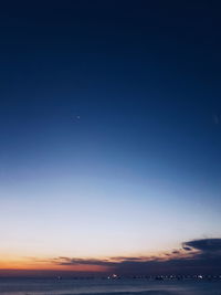 Scenic view of sea against clear sky at night