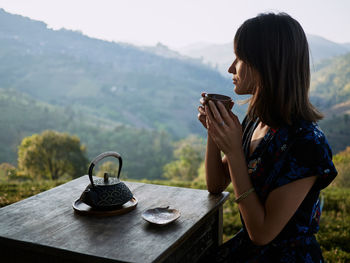 Woman drinking tea in garden